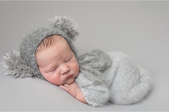 Newborn baby boy in grey hat– Professional newborn photography by Daisy May, Co. Armagh, Northern Ireland