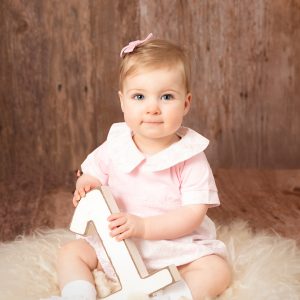 Girl enjoying her 1st birthday mini portrait photoshoot at Daisy May Photography in County Armagh