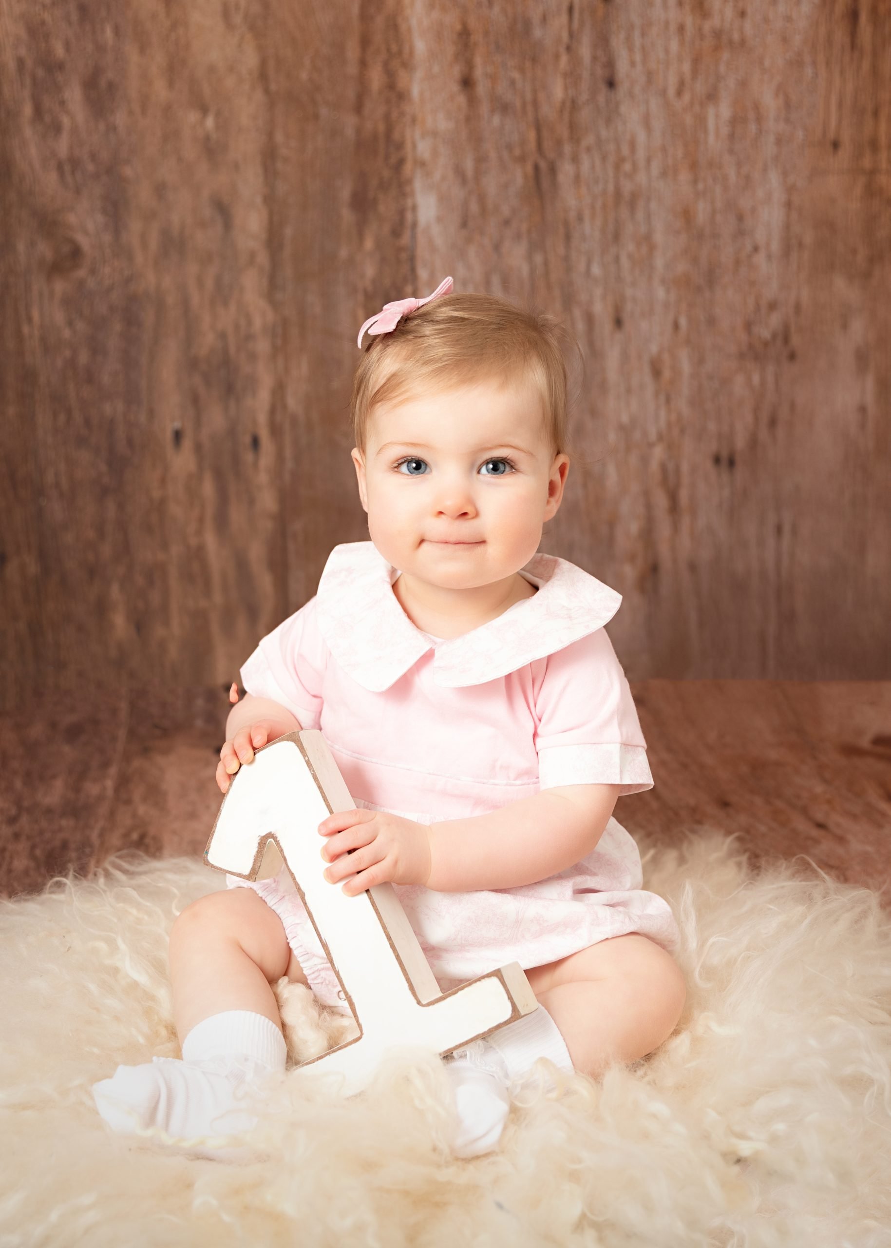 Girl enjoying her 1st birthday mini portrait photoshoot at Daisy May Photography in County Armagh
